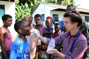 Hannah McDowell, an aid worker with Gods Missionary Church out of Penns Creek, Pa., administers medicine to a Haitian child in Leogane, Haiti, Jan. 24. Marines from Lima Company, Battalion Landing Team, 3rd Battalion, 2nd Marine Regiment, 22nd Marine Expeditionary Unit, flew into the area earlier in the day establishing a new humanitarian aid receiving area for Haitian earthquake victims at a missionary compound. (Official Marine Corps photo by Cpl. Bobbie A. Curtis)